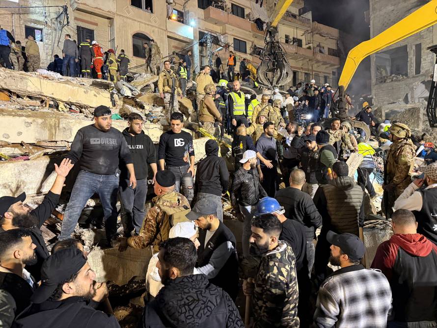 Rescue teams search for survivors after a building collapsed in Tripoli