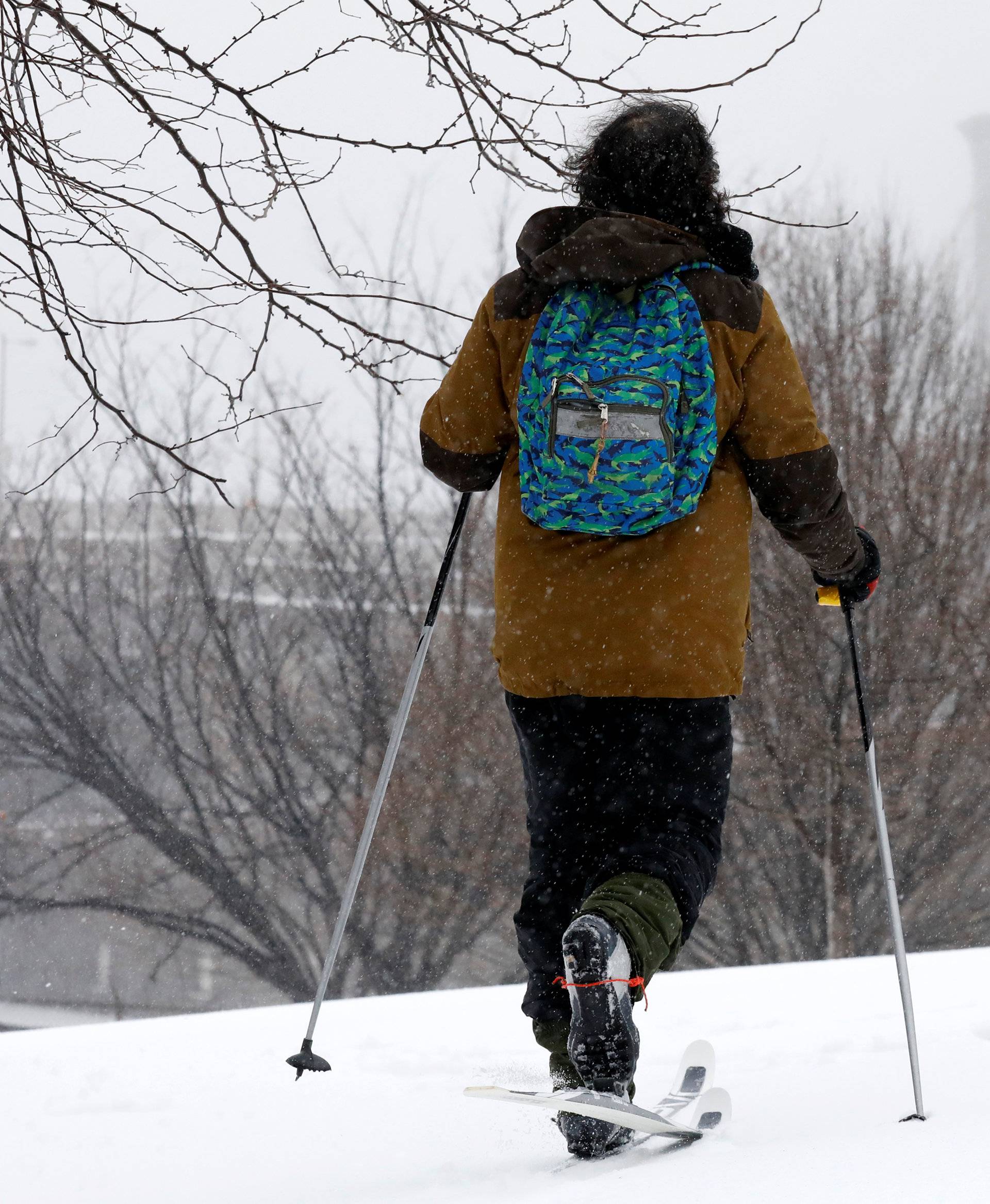 A man skis during a snow storm in the Brooklyn borough of New York