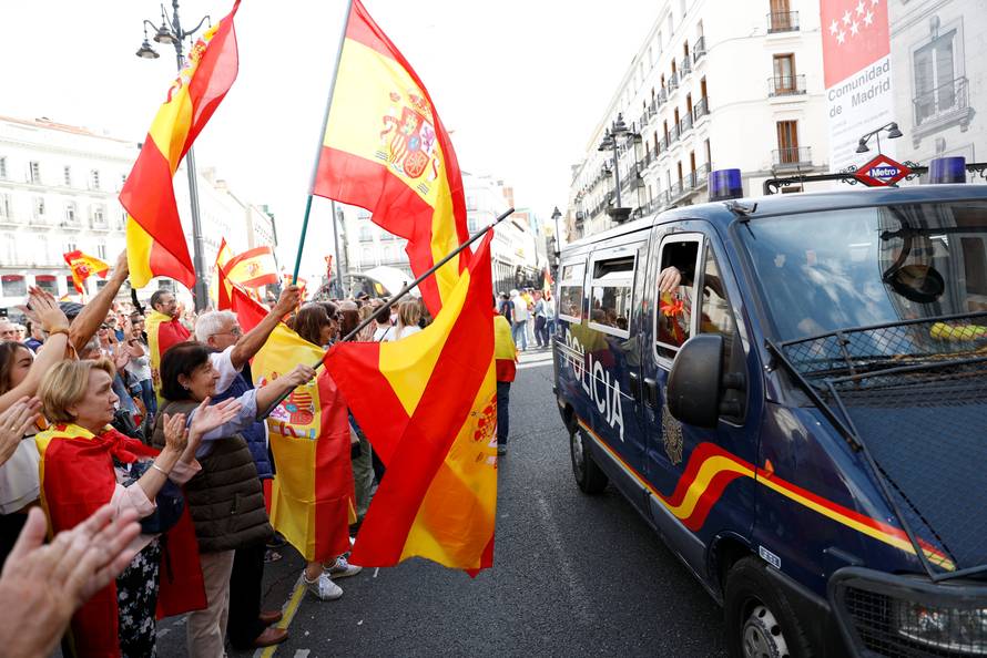 Demonstrators wave Spanish flags and support police during a demonstration in favor of a unified Spain on the day of a banned independence referendum in Catalonia, in Madrid