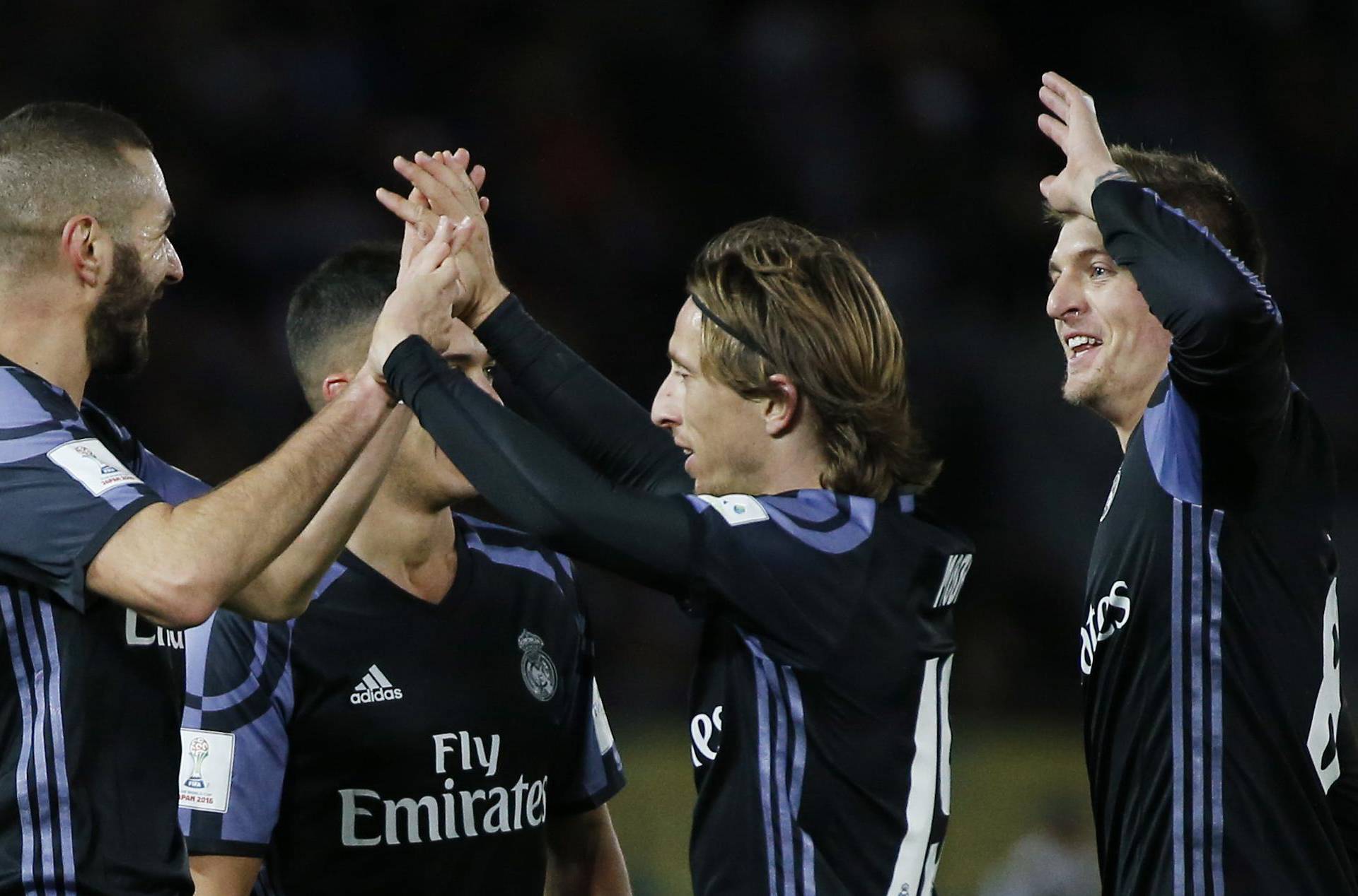 Real Madrid's Karim Benzema celebrates scoring their first goal with Luka Modric and teammates