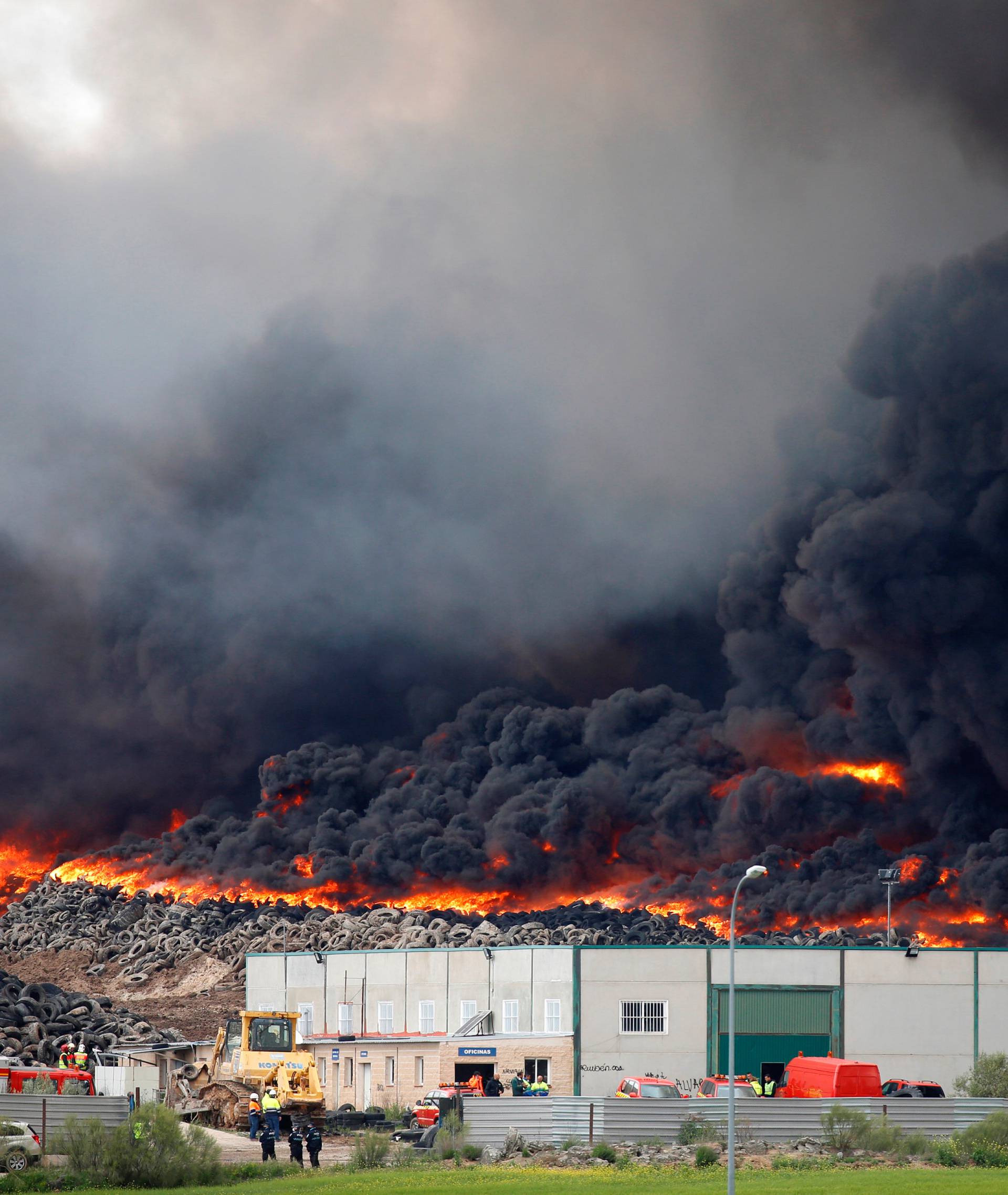 A fire rages at a tyre dump near a residential development in Sesena