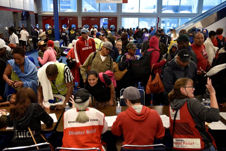 Volunteers with The American Red Cross register evacuees at the George R. Brown Convention Center after Hurricane Harvey inundated the Texas Gulf coast with rain causing widespread flooding, in Houston