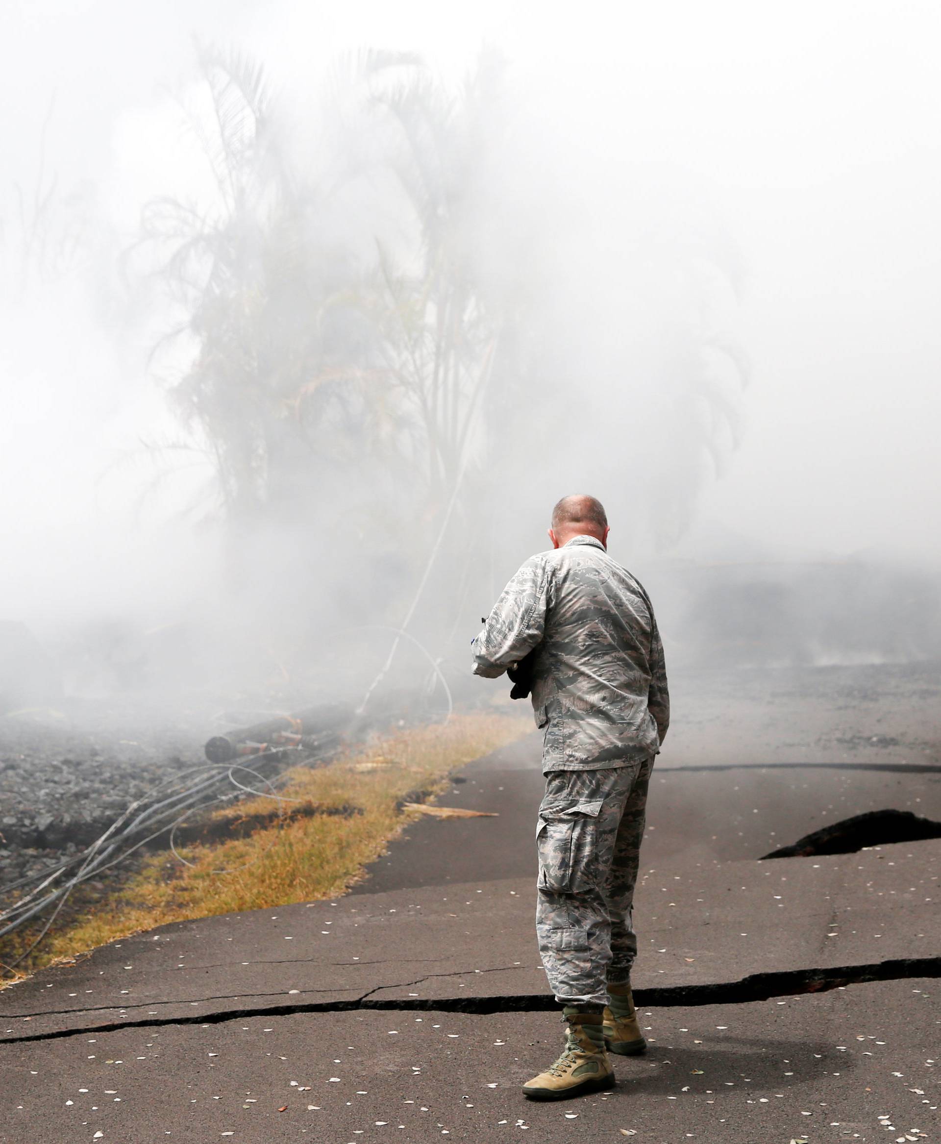 Lieutenant Colonel Charles Anthony of the Hawaii National Guard inspects road damage in Leilani Estates during ongoing eruptions of the Kilauea Volcano in Hawaii