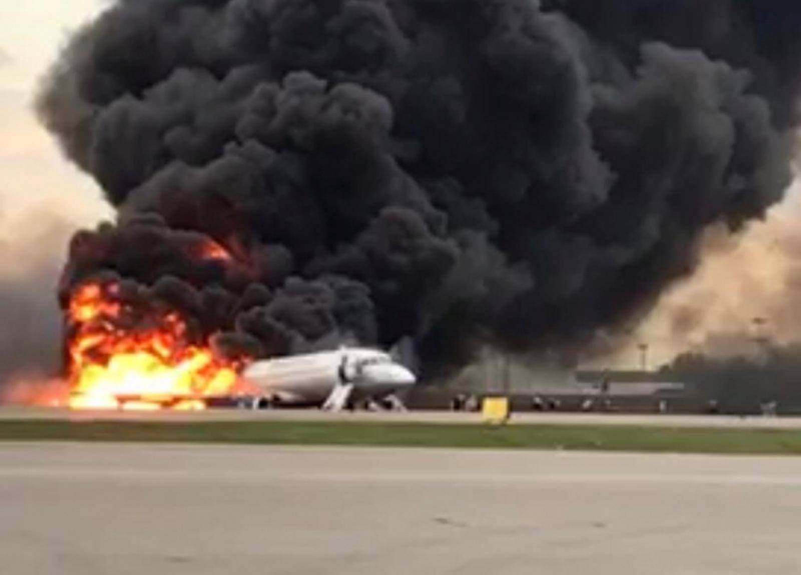 A passenger plane is seen on fire after an emergency landing at the Sheremetyevo Airport outside Moscow