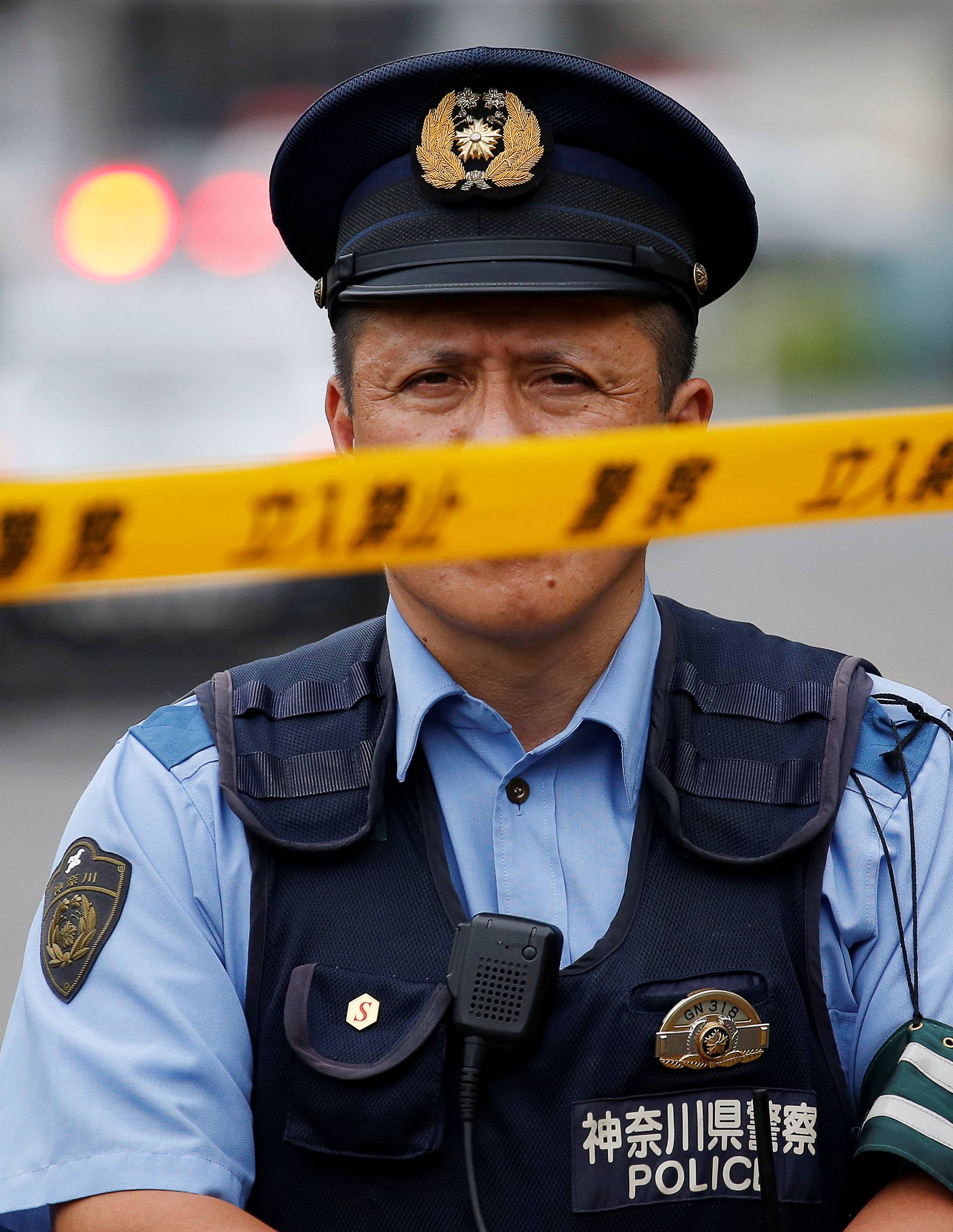 A police officer stands guard near a facility for the disabled, where a deadly attack by a knife-wielding man took place, in Sagamihara, Kanagawa prefecture, Japan