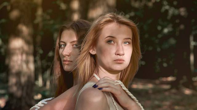 Portrait of two beautiful young women in nature. Women in love.