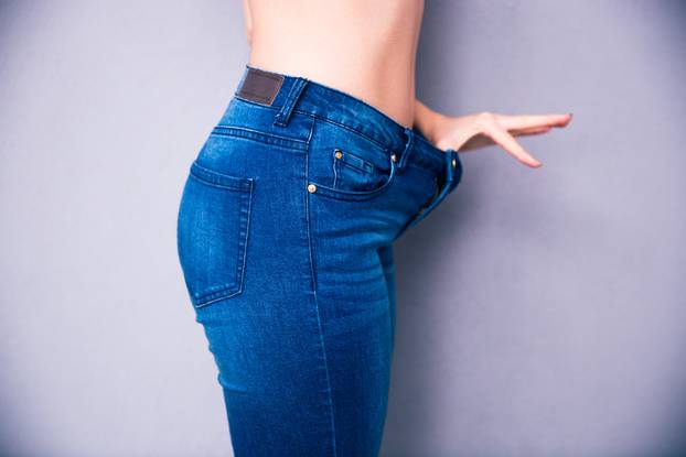 Side view portrait of a woman`s body part in jeans 