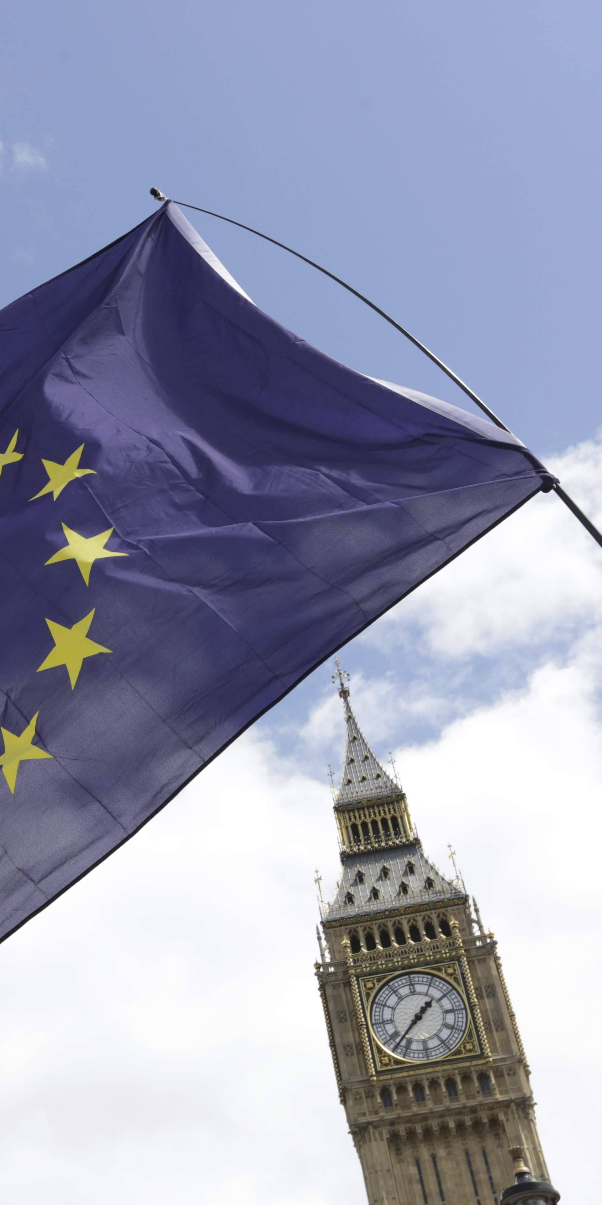 A European Union flag is held in front of the Big Ben clock tower in Parliament Square during a 'March for Europe' demonstration against Britain's decision to leave the European Union, central London