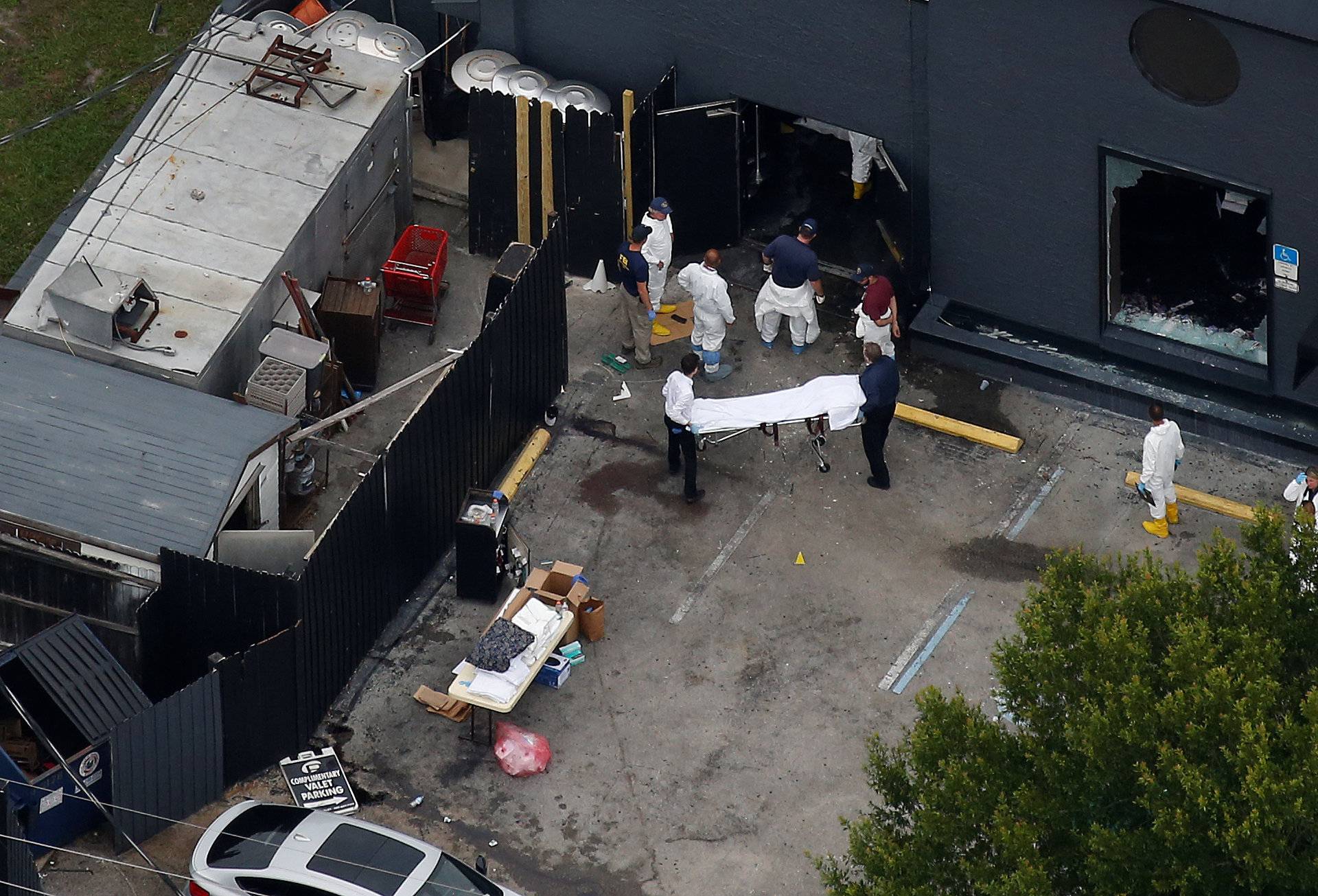 Investigators work the scene following a mass shooting at the Pulse gay nightclub in Orlando Florida