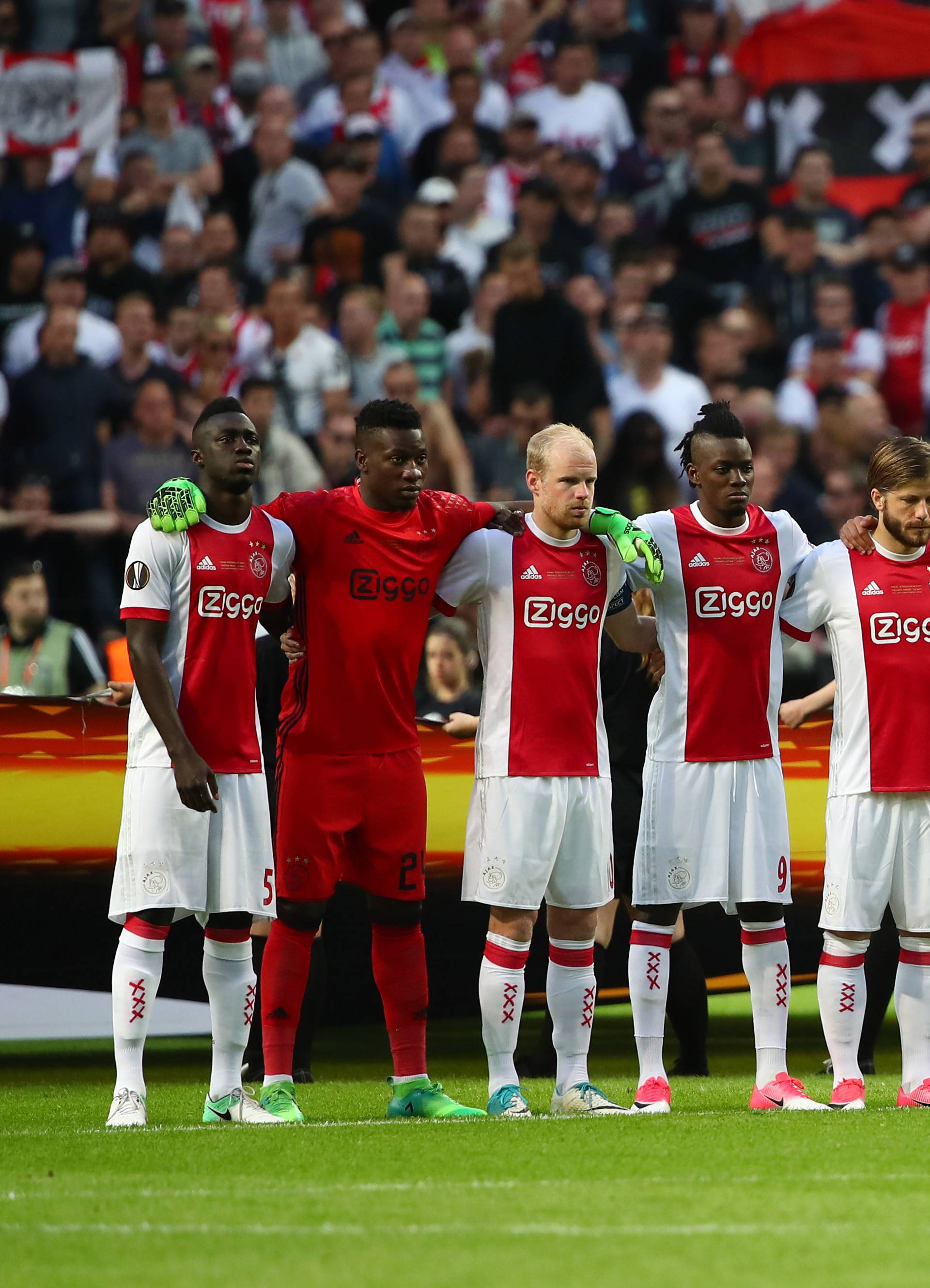 Ajax players observe a minute of silence in tribute to the victims of the Manchester attack