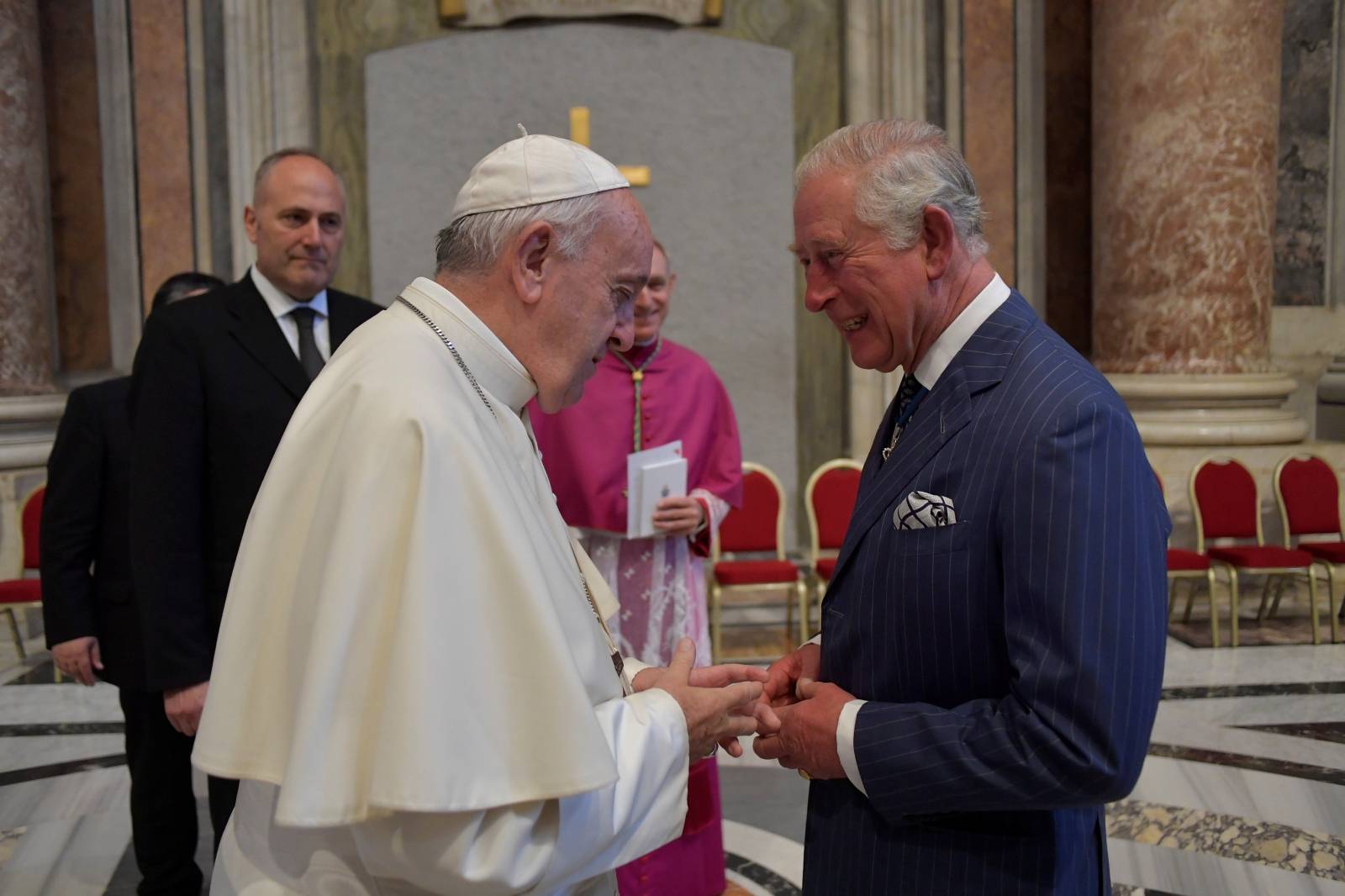 Pope Francis speaks with Britain's Prince Charles at the Vatican