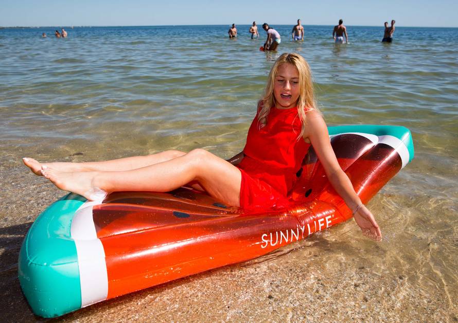 Marta Kostyuk of Ukraine sits on a float during an official event promoting the Australian Open tennis tournament at Albert Park beach in Melbourne