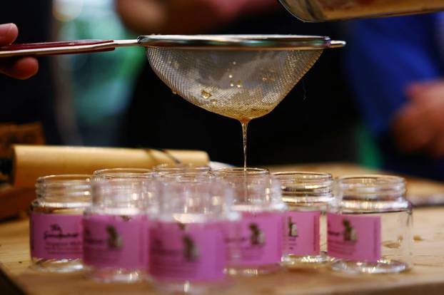 Honey is poured into jars during a honey harvesting workshop organised by bee rescuer Clarence Chua in Singapore