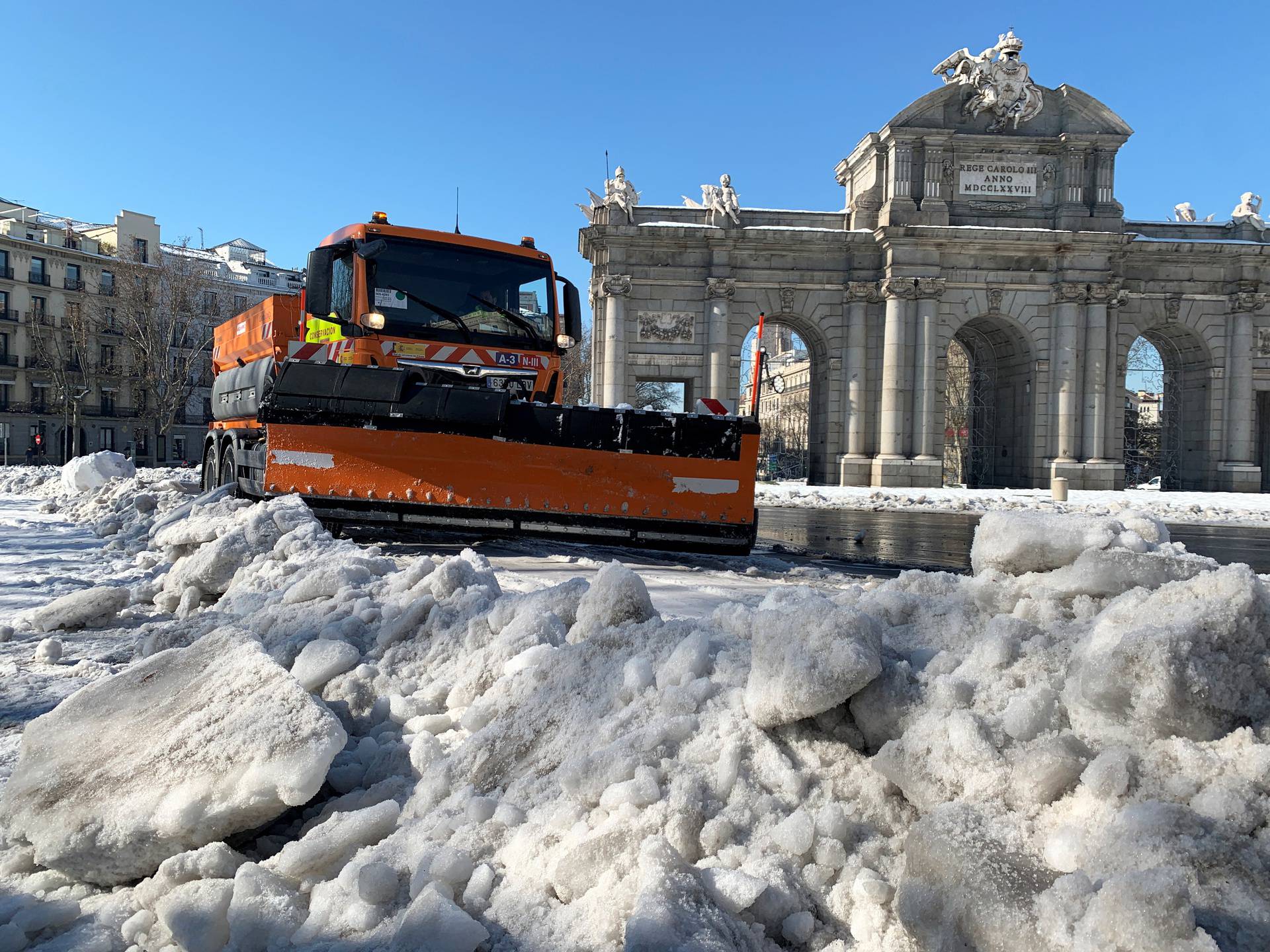 Snow plough clears the street in front of the Puerta de Alcala monument, after heavy snowfal in Madrid