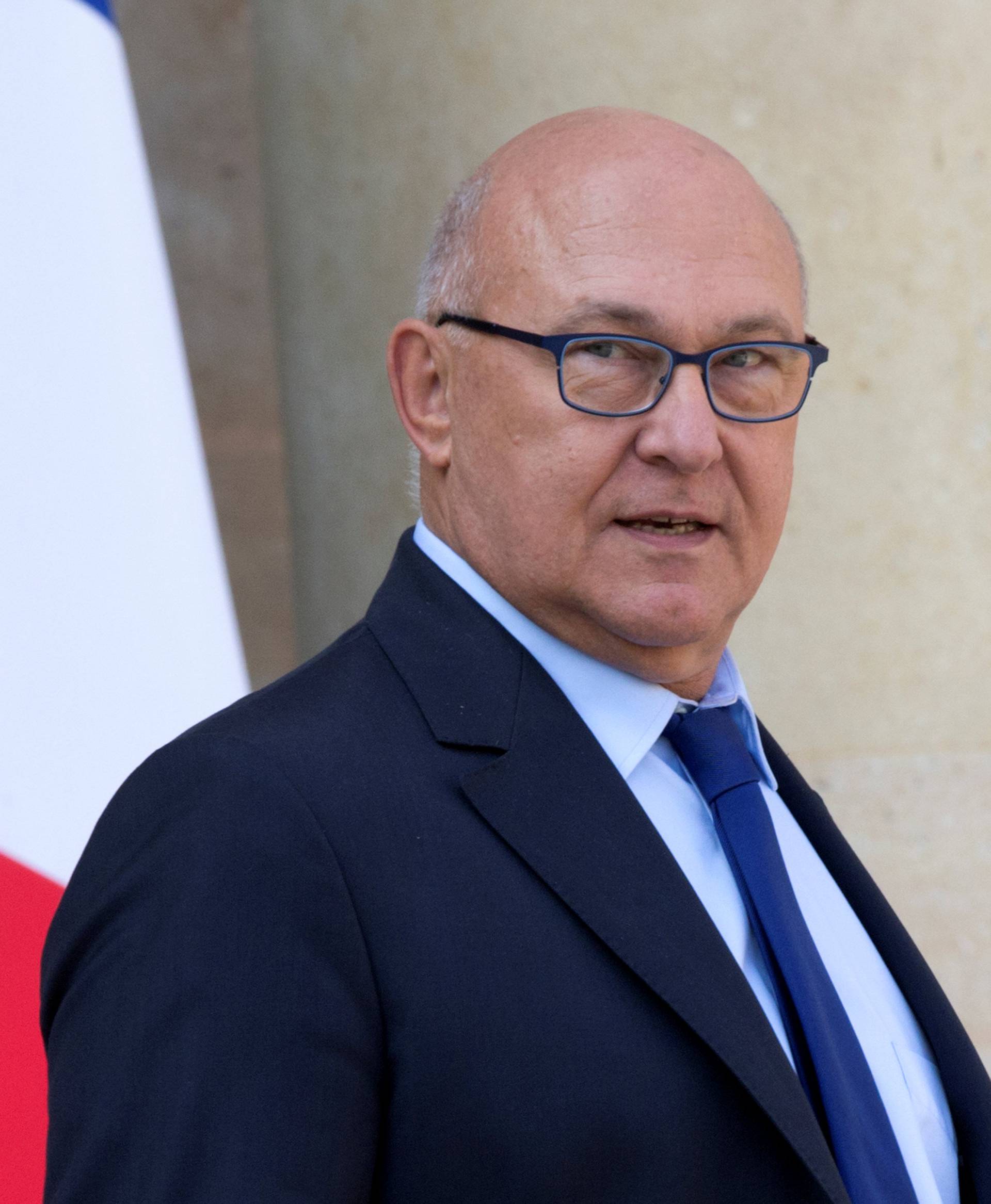 French Finance Minister Michel Sapin leaves the Elysee Palace following the weekly cabinet meeting in Paris