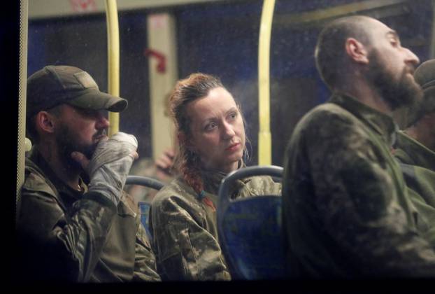 Buses carrying service members of Ukrainian forces who have surrendered after weeks holed up at Azovstal steel works arrive in Olenivka