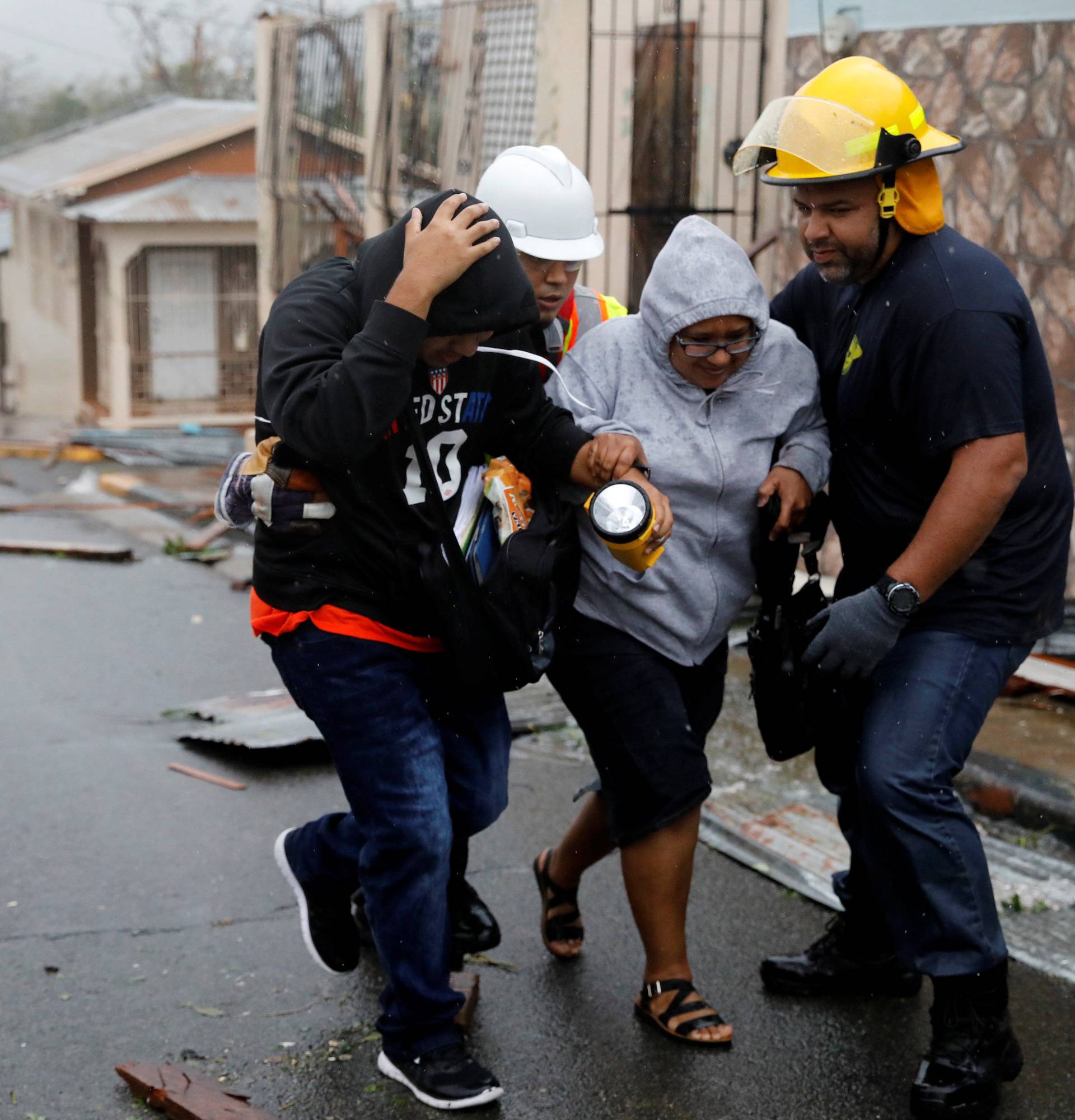 Rescue workers help people after the area was hit by Hurricane Maria in Guayama