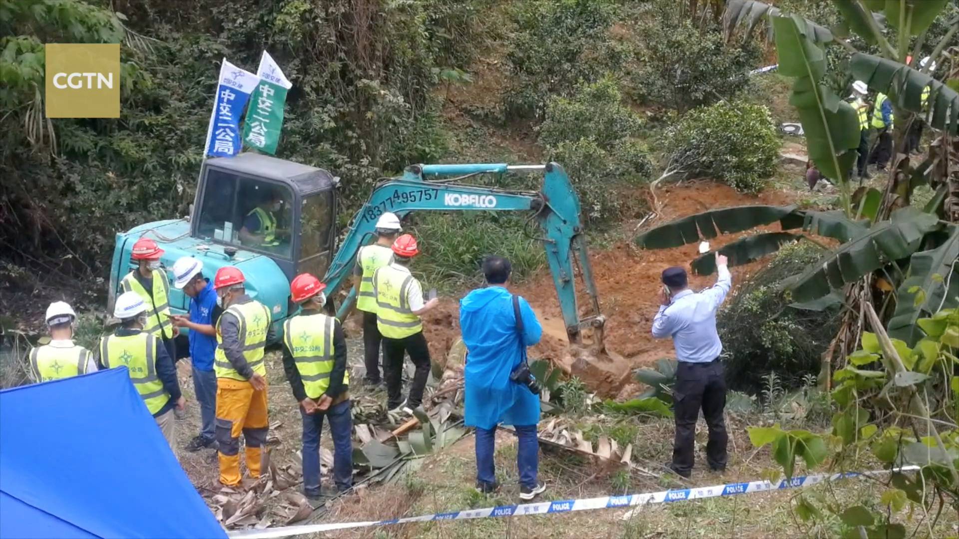 Rescuers work at the plane crash site in Wuzhou