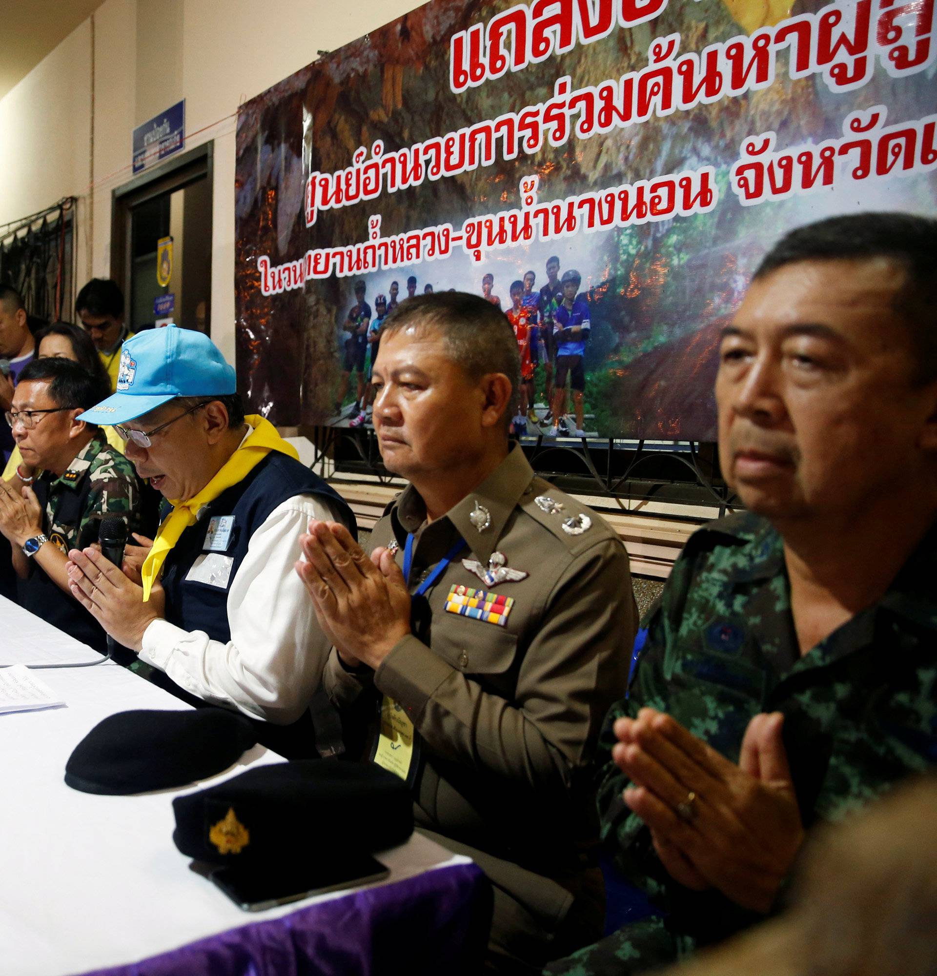 Chiang Rai province acting Gov. Narongsak Osatanakorn greets journalists during his news conference near Tham Luang cave complex in the northern province of Chiang Rai