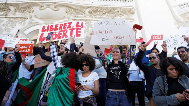 People take part in a protest against Algerian President Abdelaziz Bouteflika seeking a fifth term in a presidential election set for April 18, in Tunis