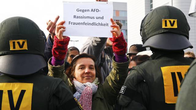 Anti-AfD protestors hold a banner reading 'Against AfD-racism and misogyny' during the AfD party congress in Stuttgart