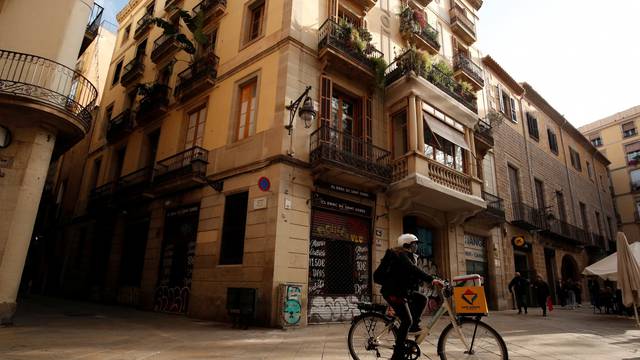 Geraldine Caillaud, member of the bicycle delivery company Les Mercedes, rides through gothic area at Barcelona's city center