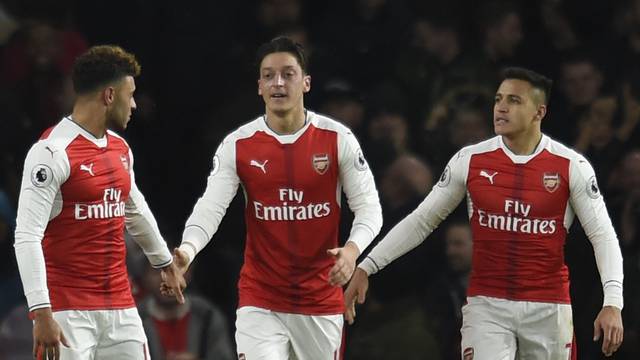 Arsenal's Mesut Ozil celebrates scoring their second goal with Alexis Sanchez and Alex Oxlade-Chamberlain
