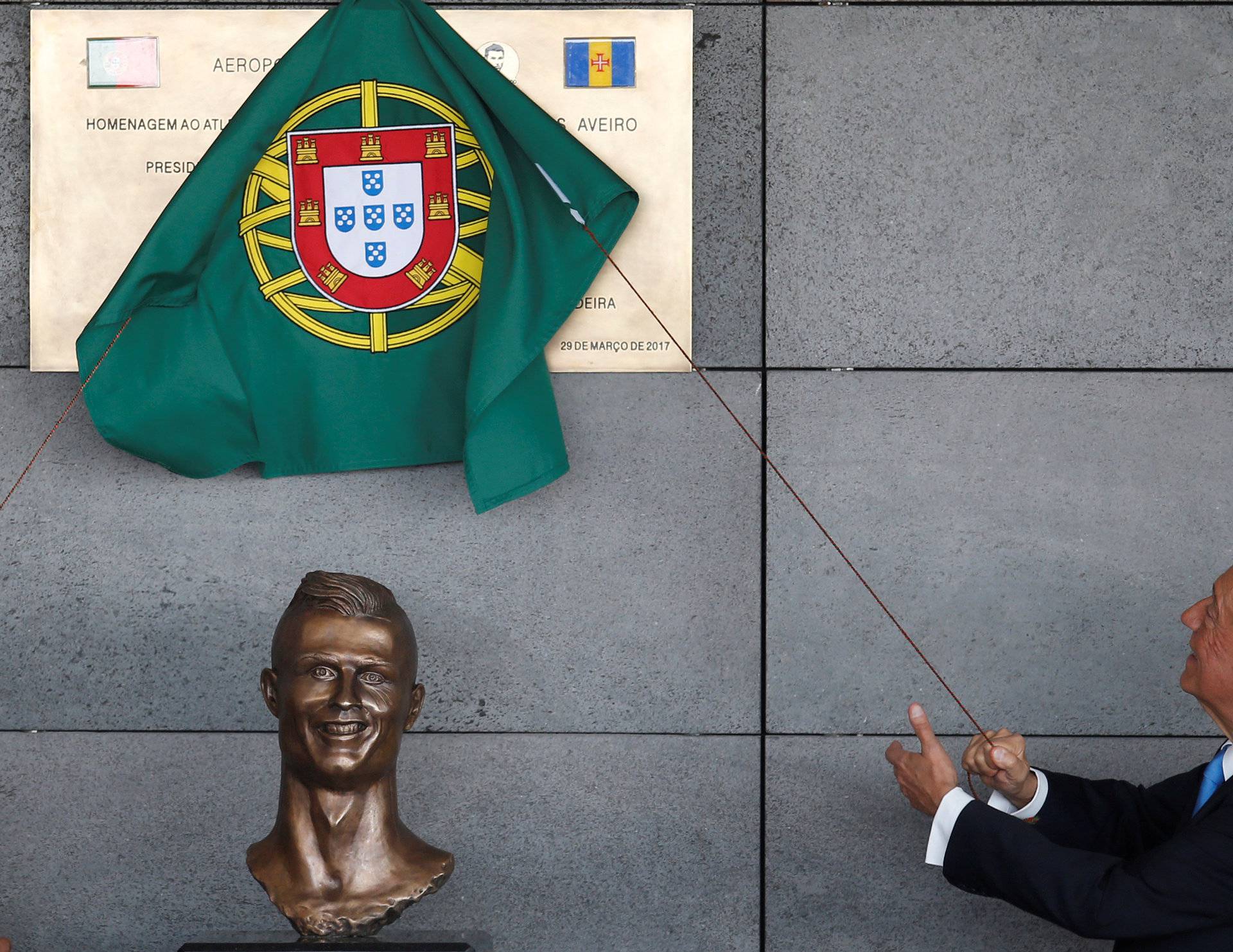 Portugal's President Marcelo Rebelo de Sousa unveils a plaque during the ceremony to rename Funchal airport as Cristiano Ronaldo Airport in Funchal