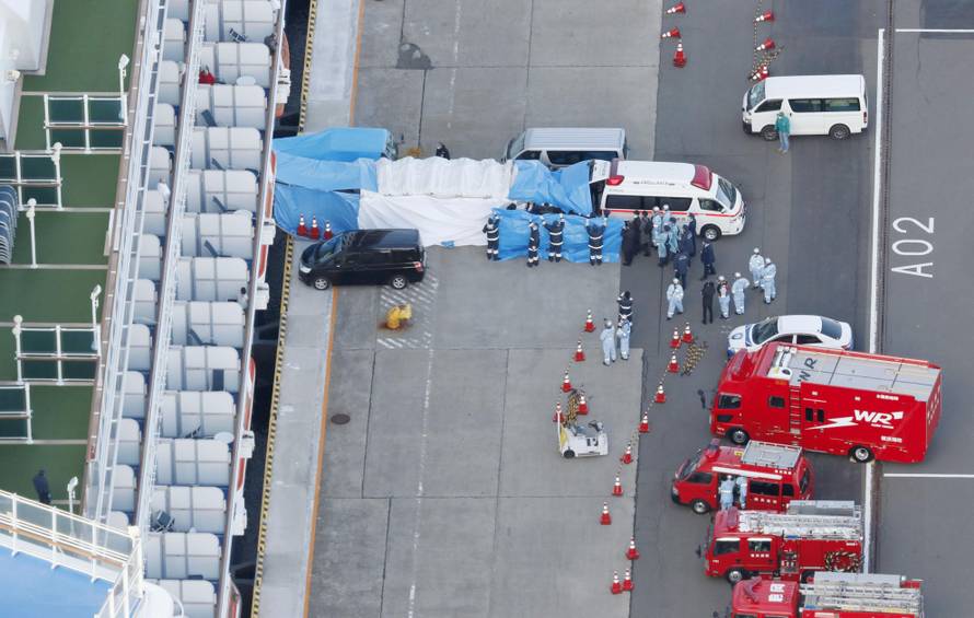 An ambulance, parked near the cruise ship Diamond Princess, which is being used to transfer to hospital people on board who have tested positive for a new coronavirus, is seen at the port of Yokohama