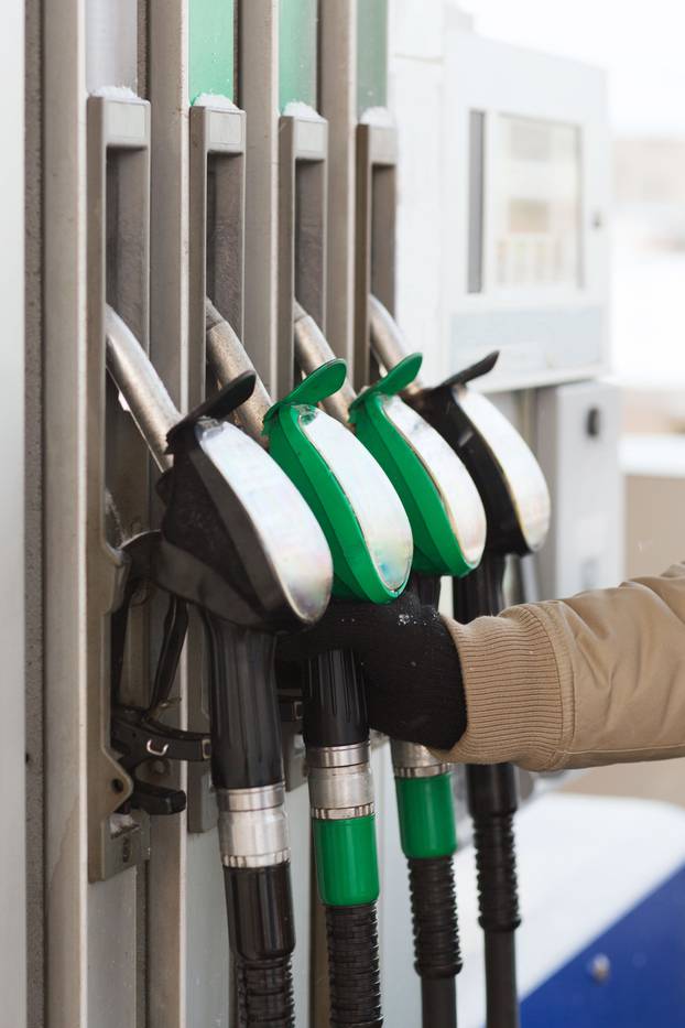 close up of male hand holding fuel pump