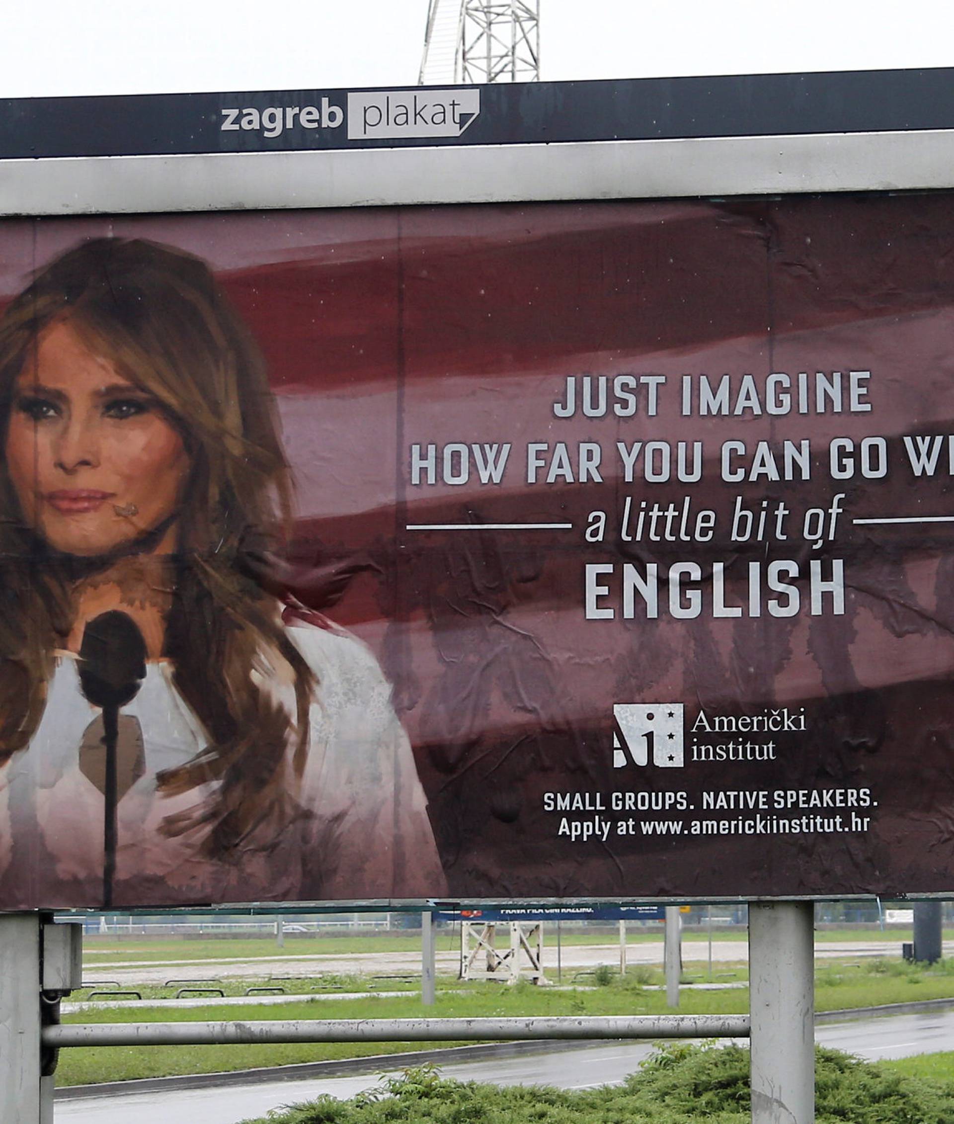 Cars drive near a billboard advertising a language school with the image of U.S. first lady Melania Trump in Zagreb, Croatia