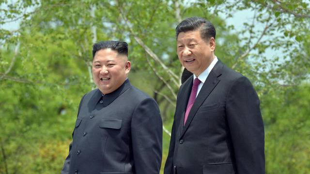 FILE PHOTO: Chinese President Xi Jinping and North Korean leader Kim Jong Un meet in Pyongyang