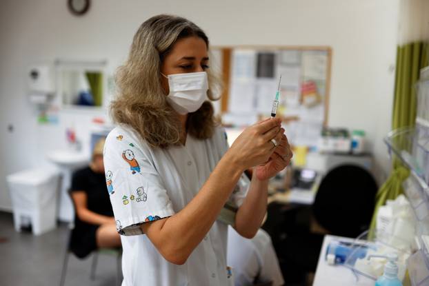 A medical worker prepares to administer a dose of a vaccine against the coronavirus disease (COVID-19) in Tel Aviv