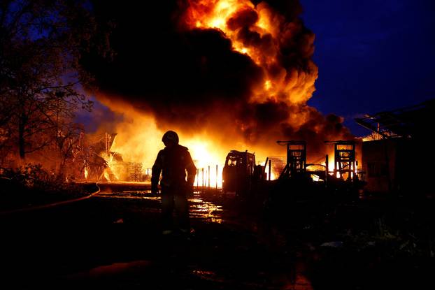 Rescuers work at the site of a Russian missile strike, amid Russia's attack on Ukraine, in Kyiv