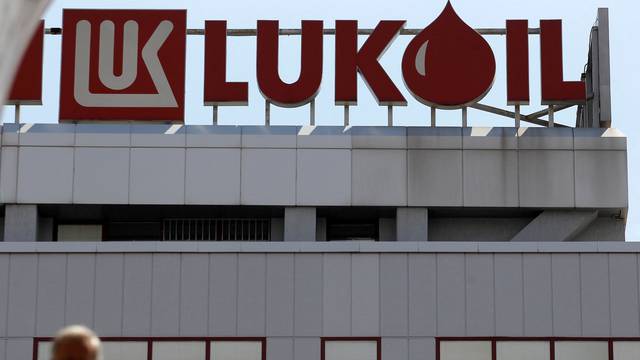 FILE PHOTO: Man walks in front of LUKOIL's headquarters in Sofia