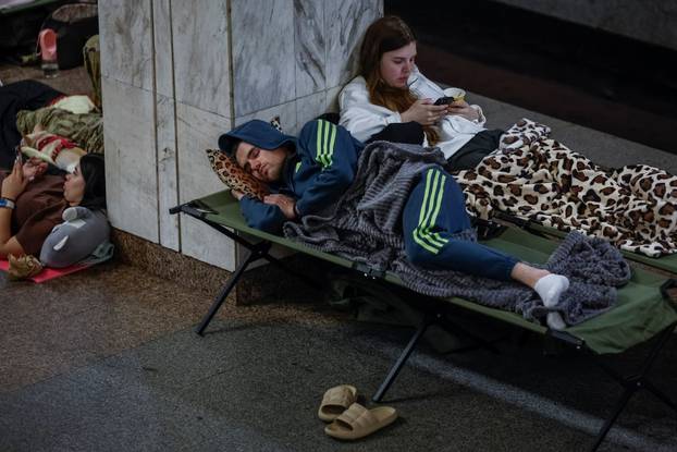 People take shelter inside a metro station during an air raid alert in Kyiv