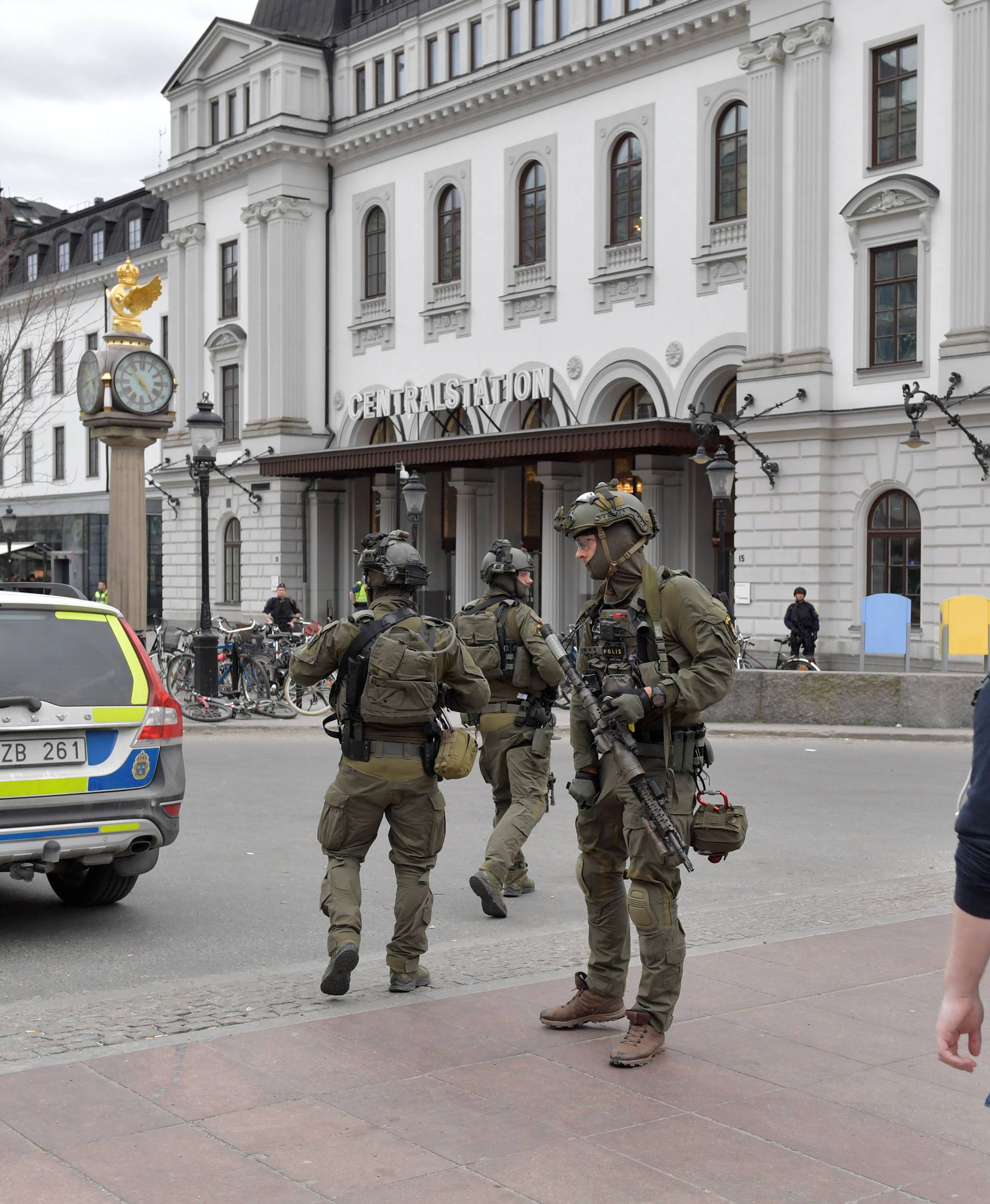 Police officers are seen outside Stockholm Central station after people were killed when a truck crashed into department store Ahlens, in central Stockholm