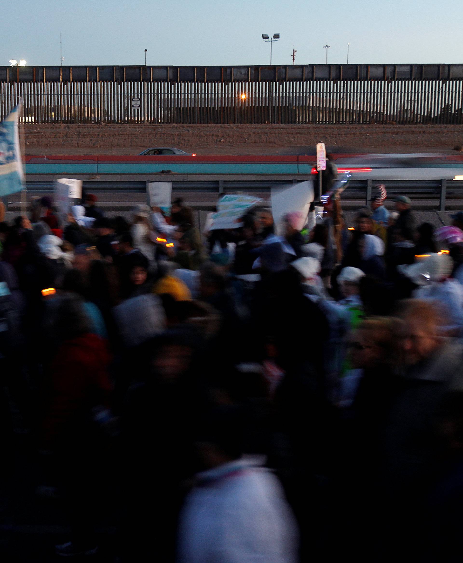 Demonstrators march along the border fence during the 'March for Truth: Stop the Wall, Stop the Lies' during the visit of U.S. President Trump to El Paso