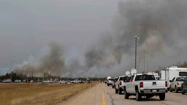 Ontario firefighters in pickup trucks drive into wildfires near Fort McMurray