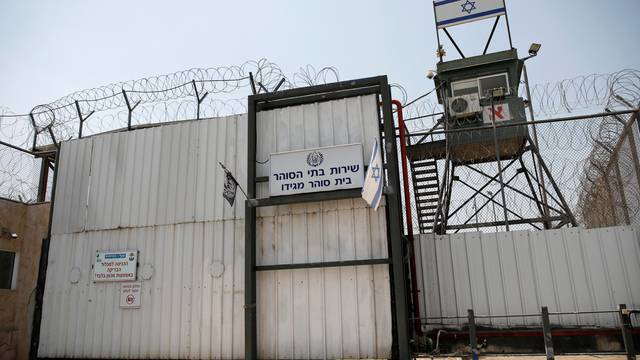 An Israeli flag is seen next to the gate of the Megiddo Prison