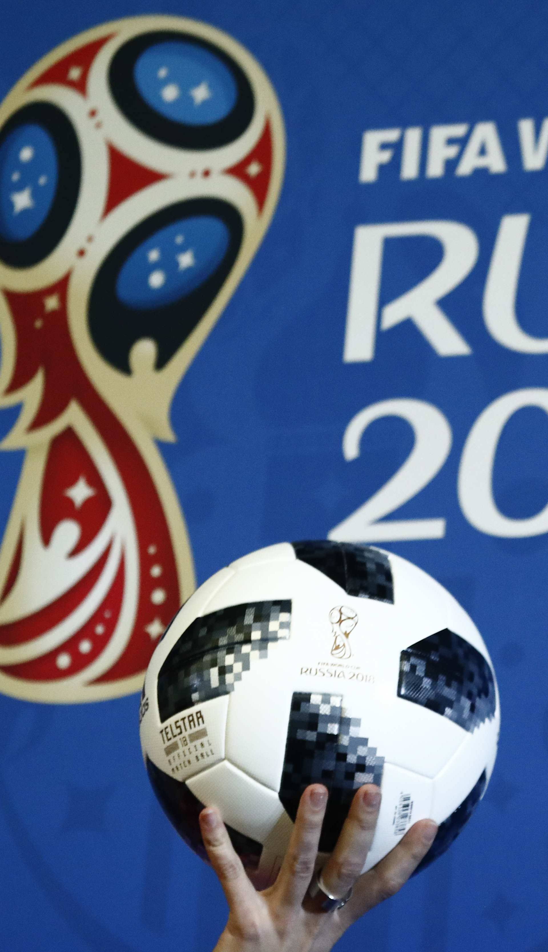 A presenter holds the official match ball for the 2018 FIFA World Cup Russia during an event to announce the new 2018 FIFA Fan Fest Ambassadors in Moscow