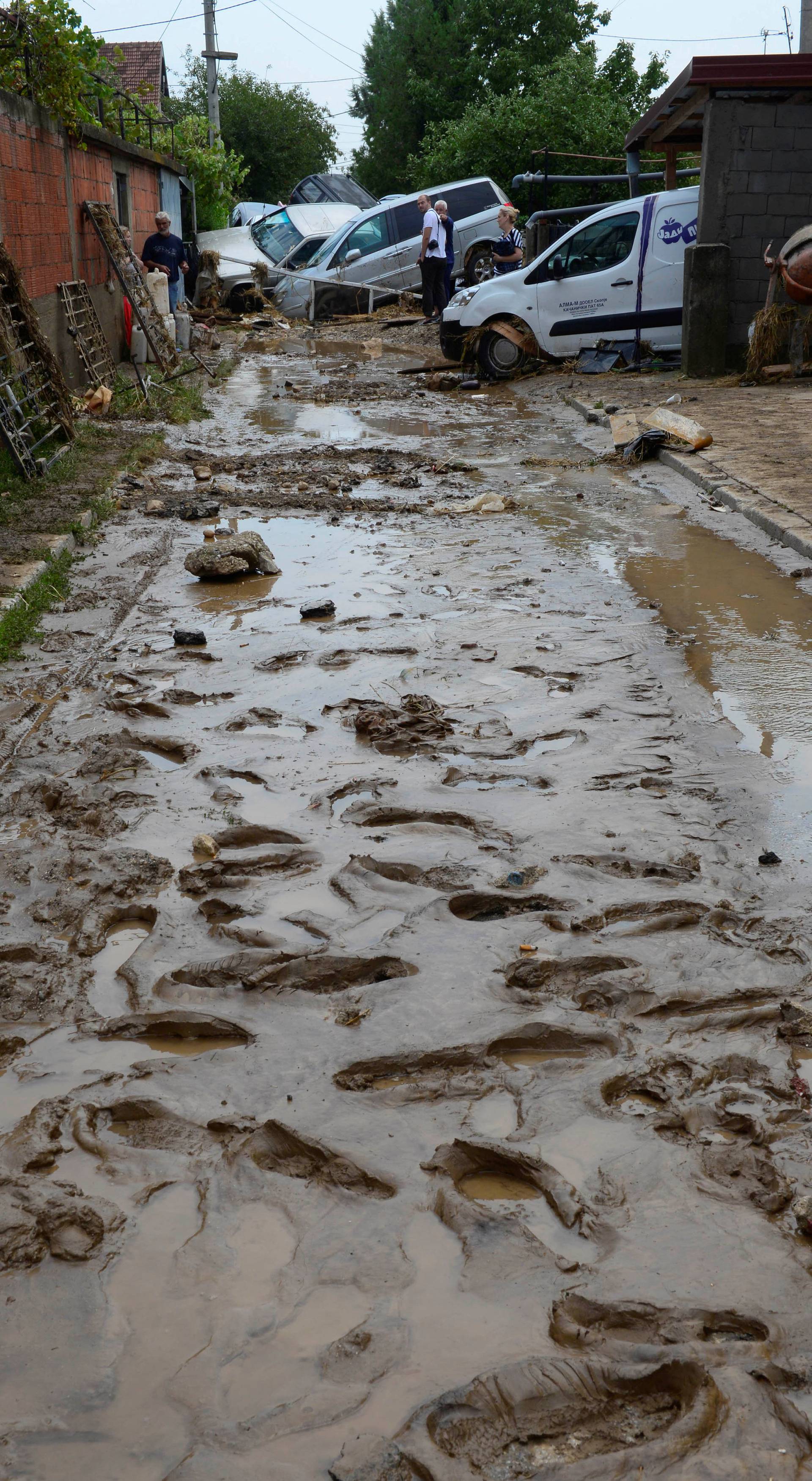 People walk on the street after heavy floods in Cento near Skopje