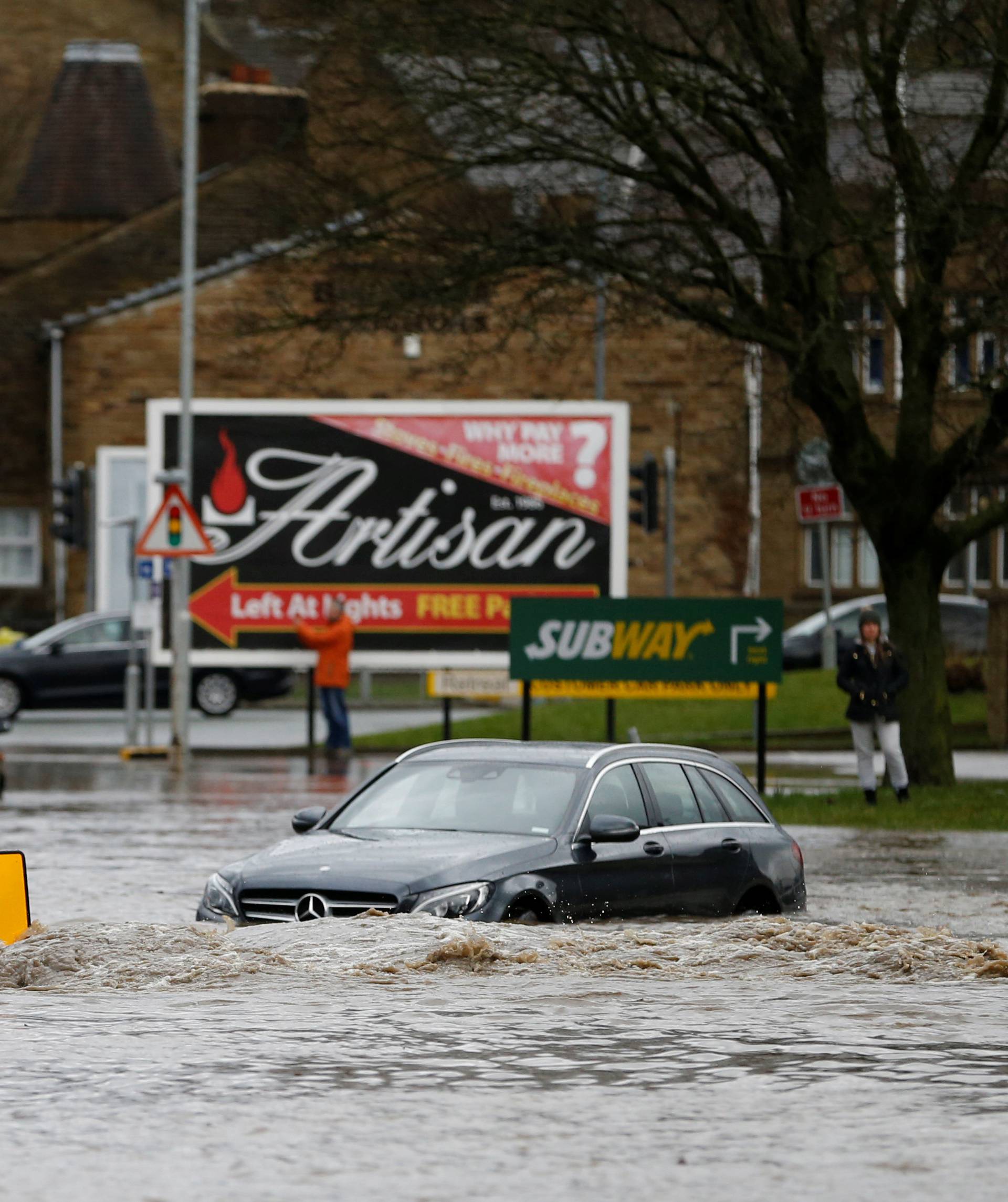 Cars sit in floodwater in Brighouse, West Yorkshire