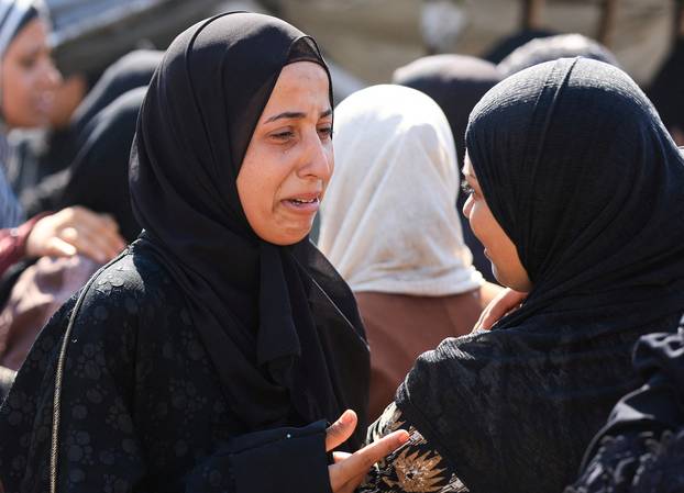 Mourners attend the funeral of Palestinians killed in overnight Israeli airstrikes, in Gaza City