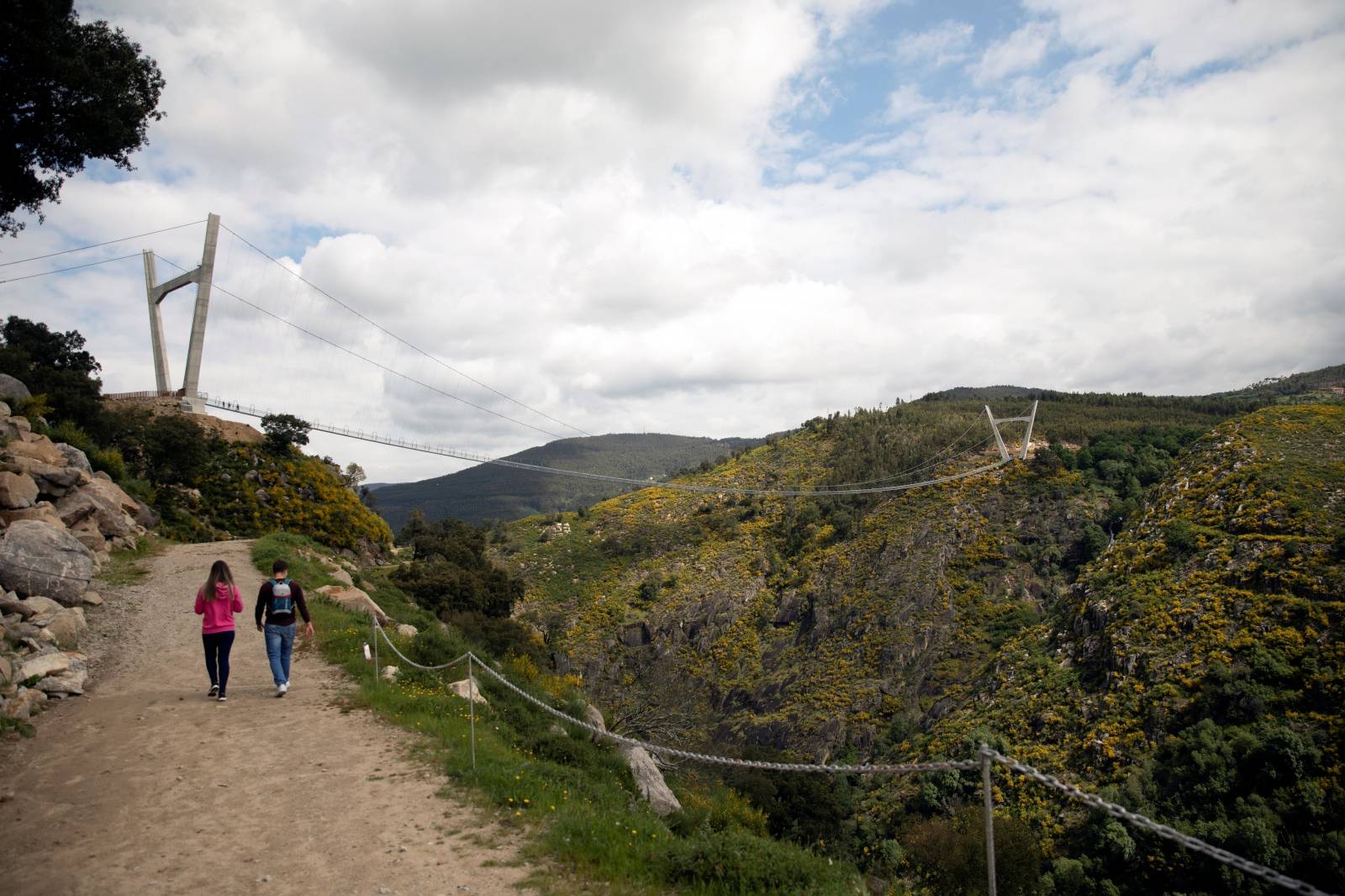 People walk on the world's longest pedestrian suspension bridge '516 Arouca', in Arouca