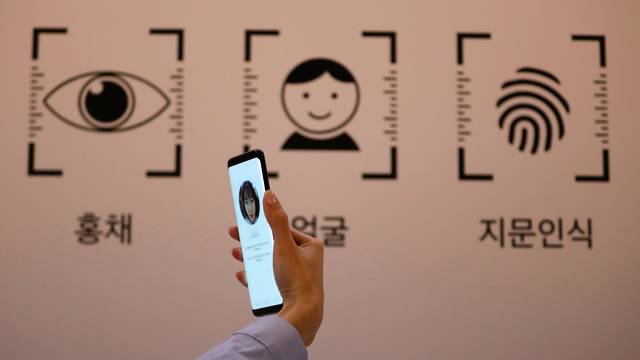 An employee demonstrates a Samsung Electronics' Galaxy S8 smartphone during a media event at a company's building in Seoul