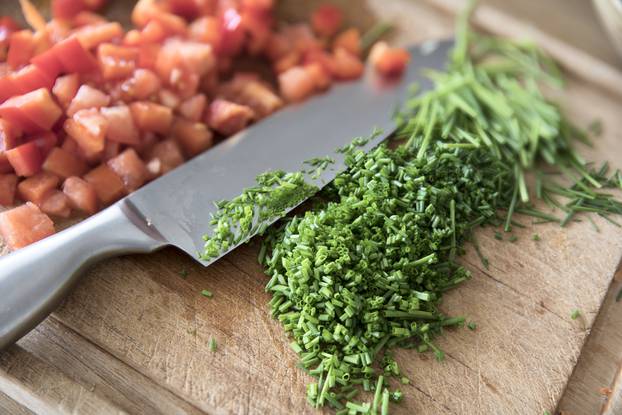 Chopped,Chives,On,Cutting,Board,With,Chef's,Knife,And,Chopped