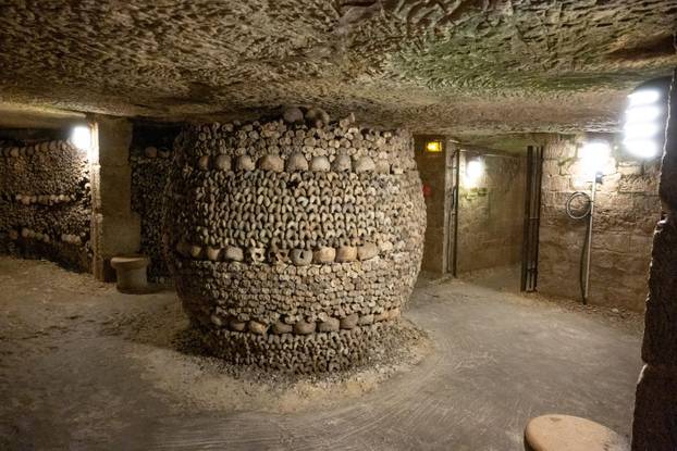 In the Paris Catacombs, a long underground path with structures formed by human bones, near Montparnasse, Paris, France