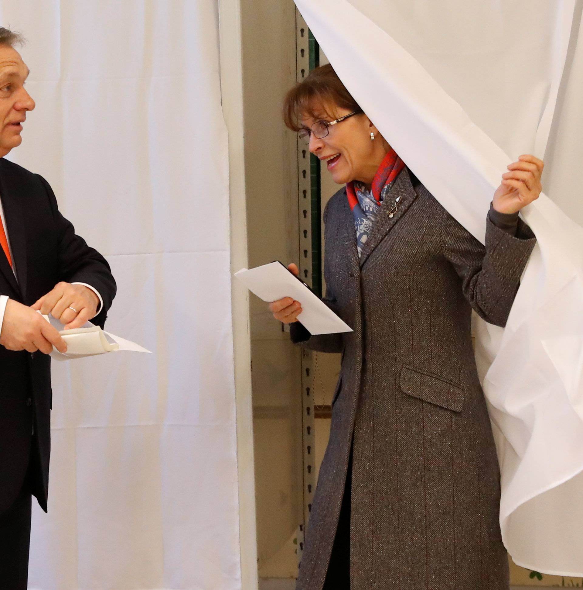 Current Hungarian Prime Minister Viktor Orban and his wife Aniko Levai leave a polling booth to cast their ballots during Hungarian parliamentary election in Budapest