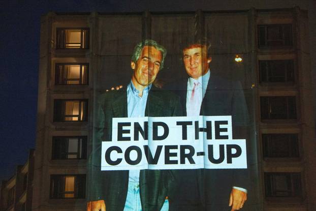 Documents and photos of Jeffrey Epstein and U.S. President Trump projected onto Hilton ahead of WHCA Gala, in Washington, D.C.